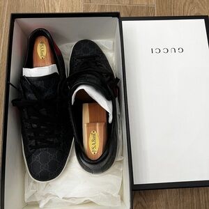 Gucci Men’s Black GG Monogram Low-Top Sneakers with Red Stripe.